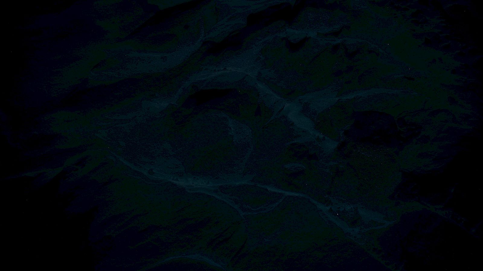 The image is very dark, making it difficult to discern specific details or objects.