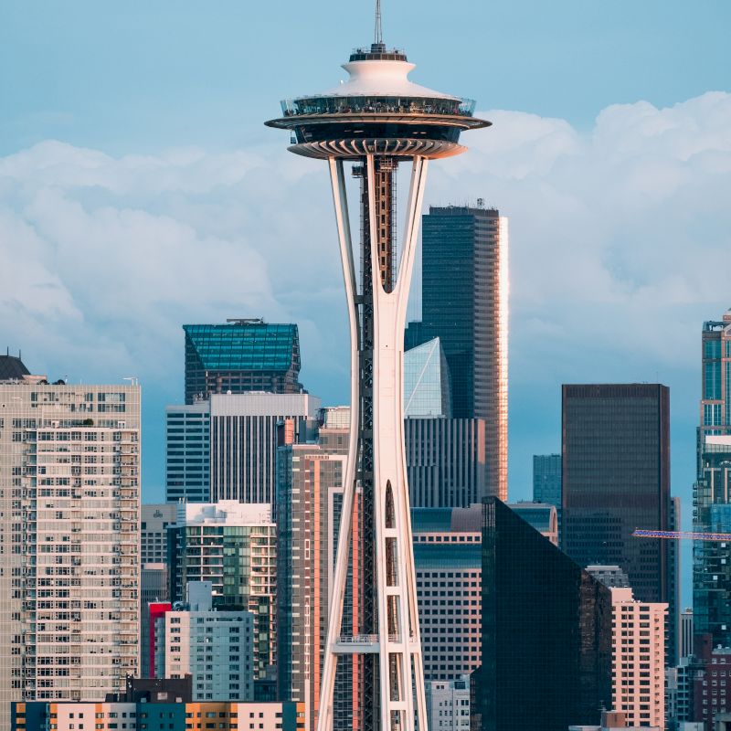 The image shows the Seattle skyline with the Space Needle in the foreground and various skyscrapers in the background.